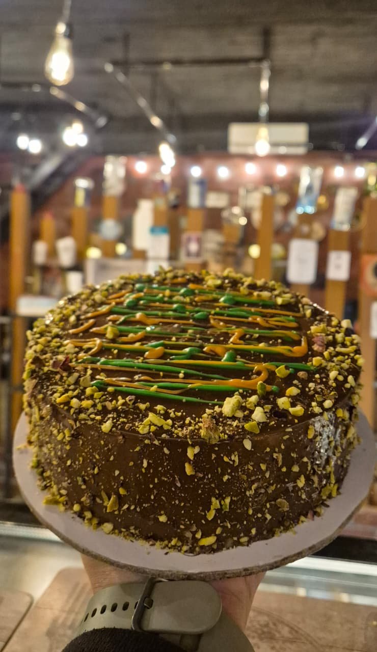 The Dubai chocolate cake, topped with pistachio and crisp kunafa