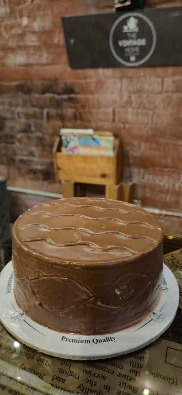 A chocolate ganache cake on the counter