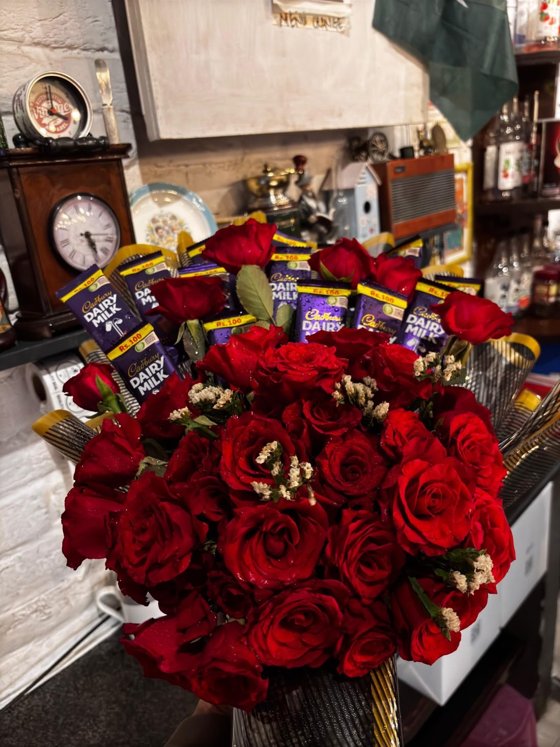 A bouquet of roses with chocolate bars set among them