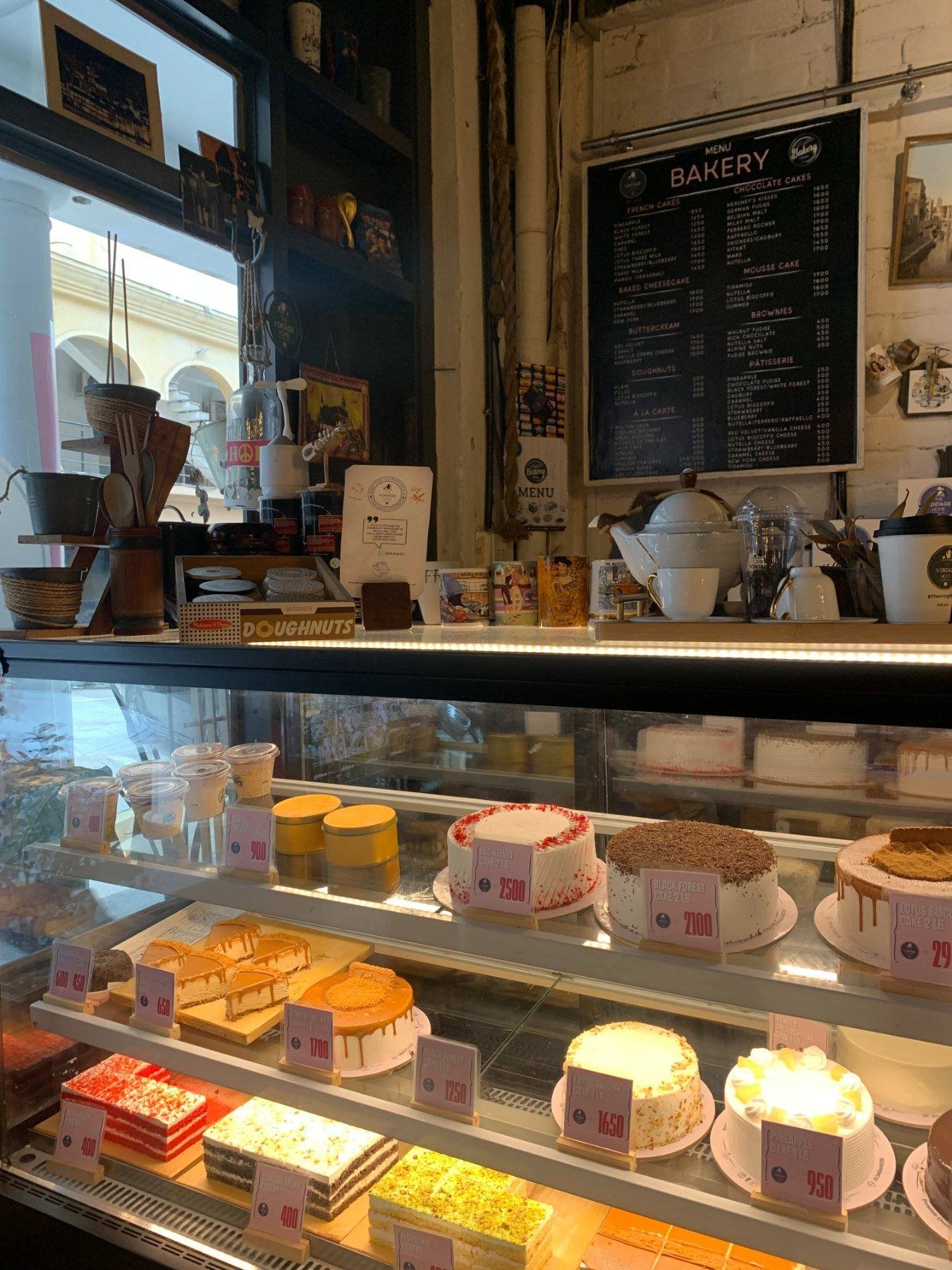 The cake counter and the chalkboard menu above it